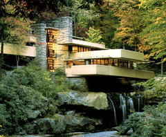 Frank Lloyd Wright's Fallingwater cultivates an organic relationship between the building and its location by: